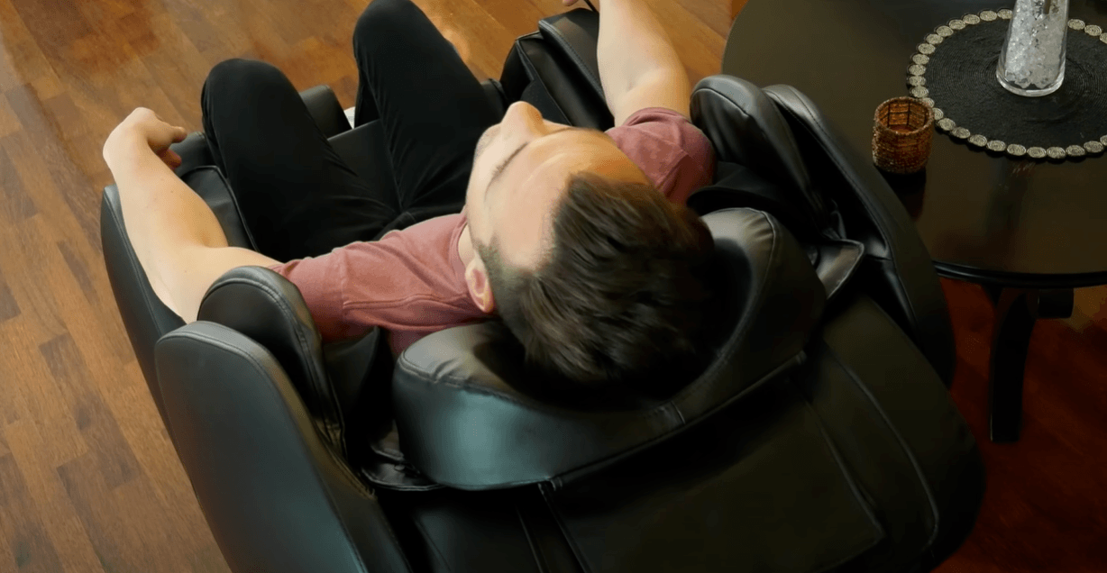 a man is sleeing on massage chair