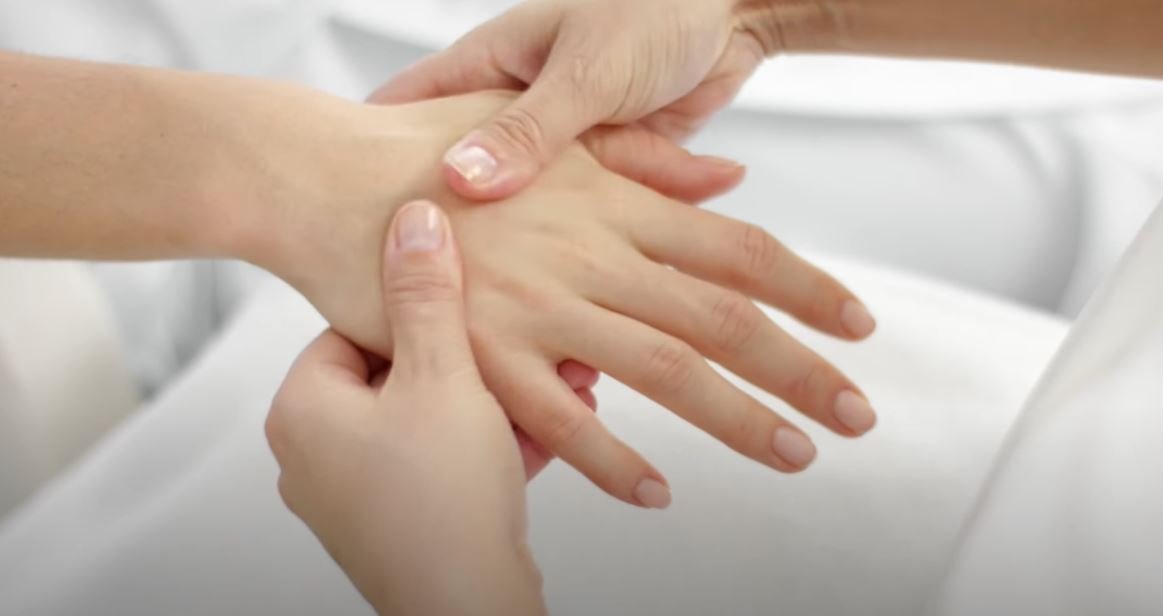 A-Hand-Massage-The-Health-Benefit woman relaxing by hand massage